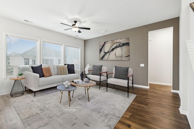 living room with dark hardwood / wood-style floors and ceiling fan