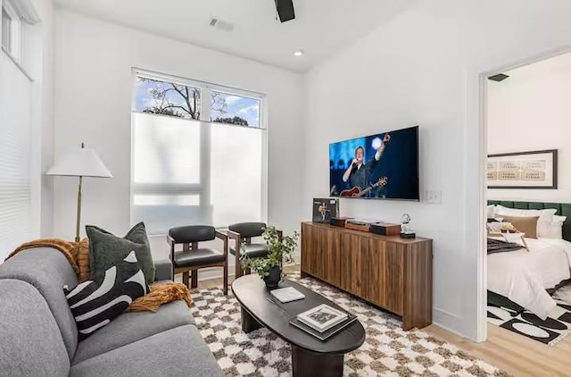 living room with light hardwood / wood-style floors and ceiling fan