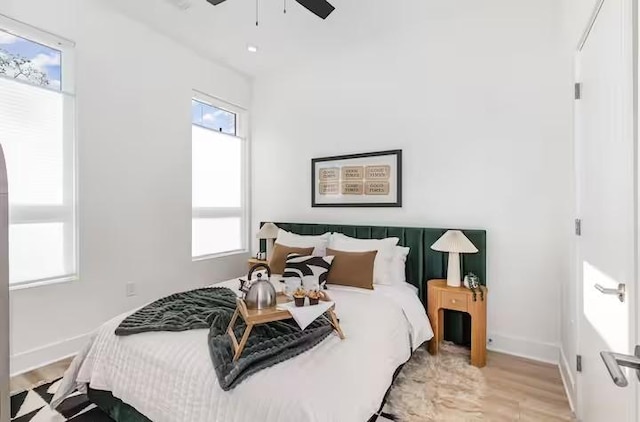 bedroom with ceiling fan and light wood-type flooring