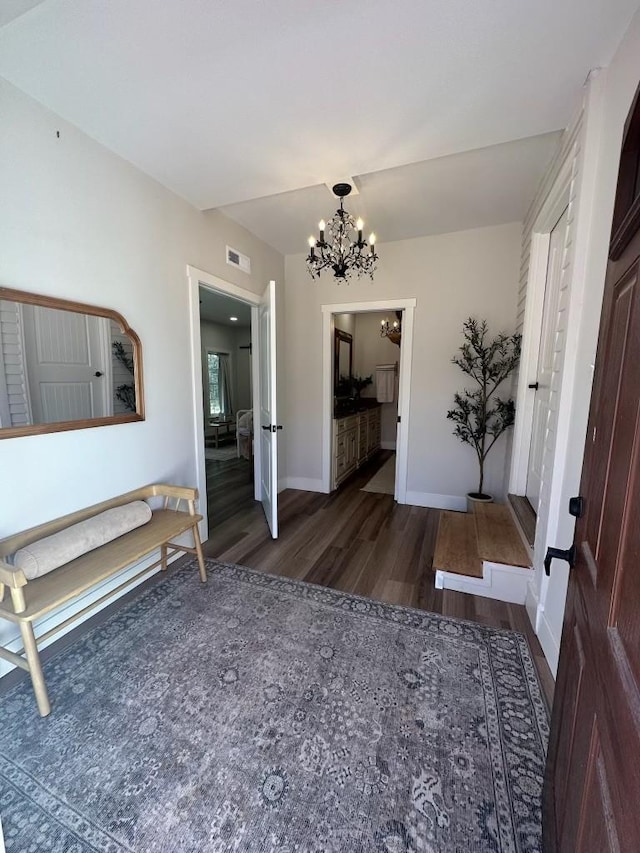 interior space featuring dark hardwood / wood-style flooring and an inviting chandelier