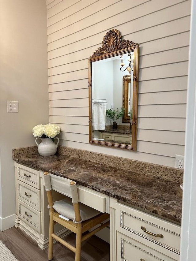 room details with hardwood / wood-style flooring and built in desk