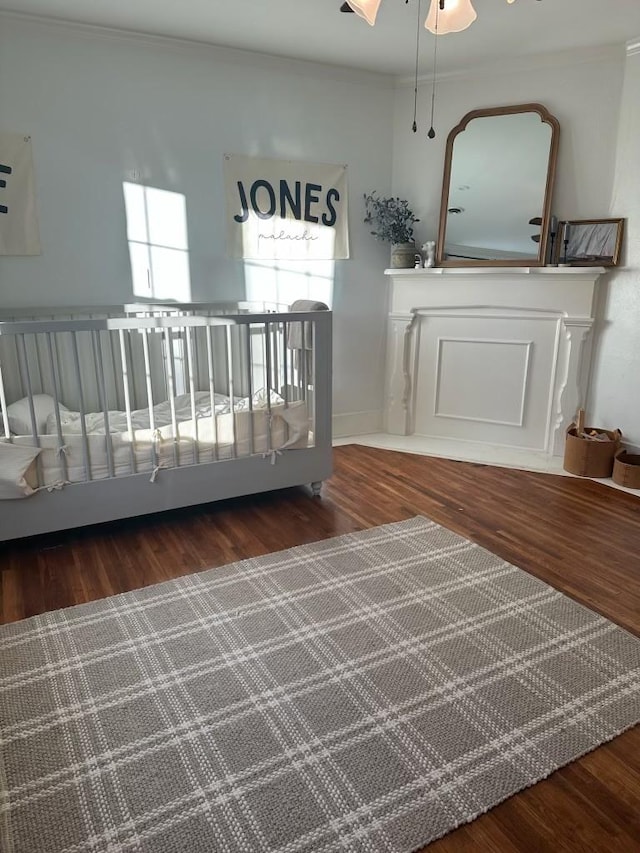 unfurnished bedroom with crown molding and wood-type flooring