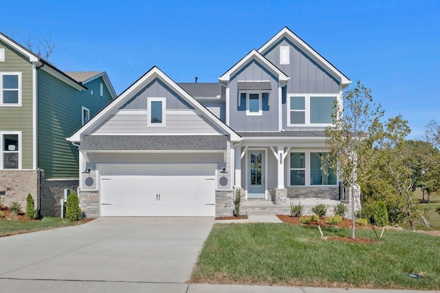 craftsman inspired home featuring a garage and a front yard