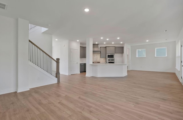 unfurnished living room featuring light wood-type flooring