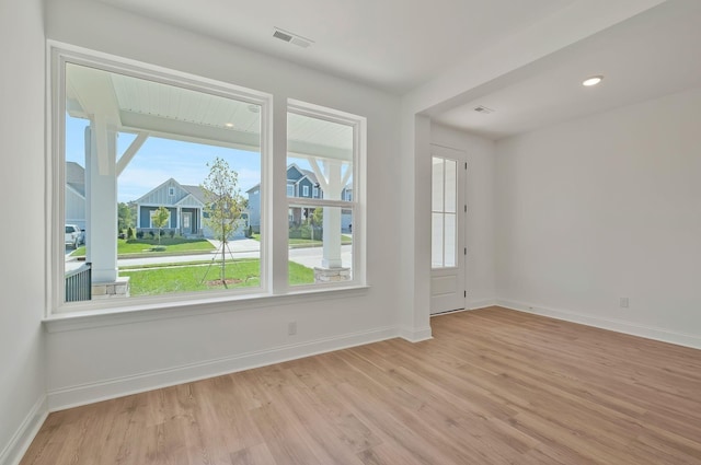 spare room featuring light hardwood / wood-style floors