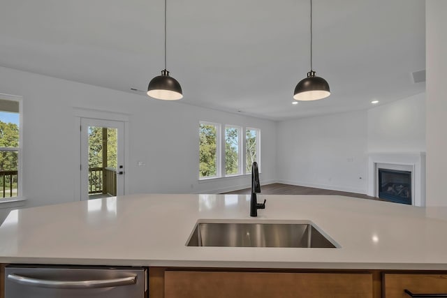 kitchen with sink, decorative light fixtures, plenty of natural light, and dishwasher