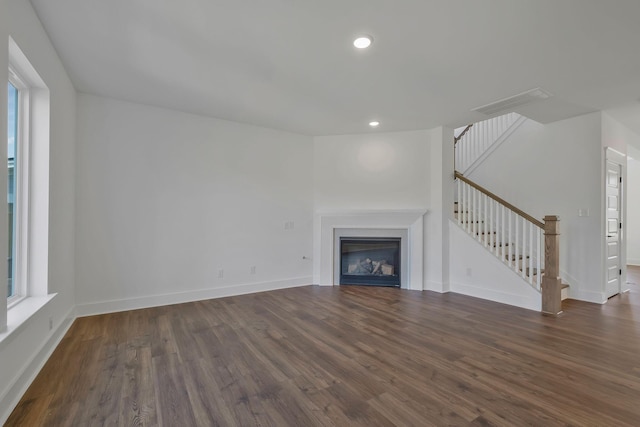 unfurnished living room featuring dark hardwood / wood-style floors