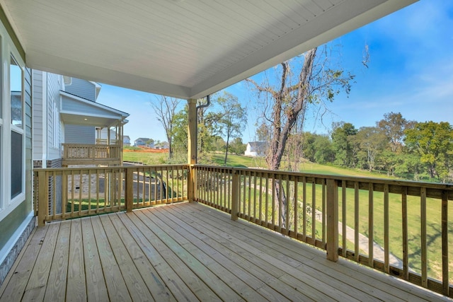 wooden deck featuring a yard