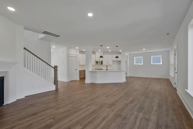 unfurnished living room with dark hardwood / wood-style flooring