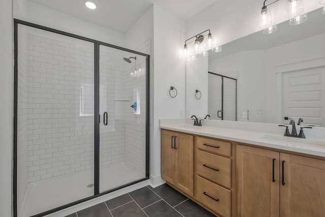 bathroom featuring a shower with door, vanity, and tile patterned floors