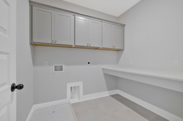 laundry room featuring cabinets, electric dryer hookup, hookup for a washing machine, and light tile patterned floors