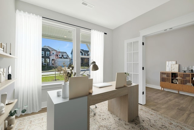 home office featuring a healthy amount of sunlight and light hardwood / wood-style floors