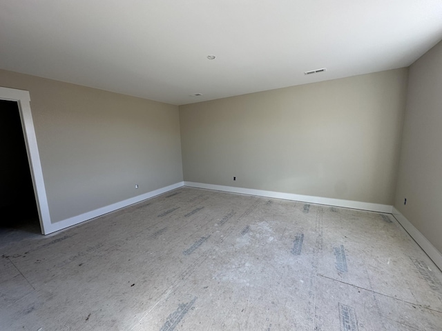 spare room featuring visible vents and baseboards