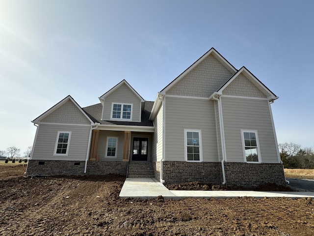 craftsman-style house featuring brick siding