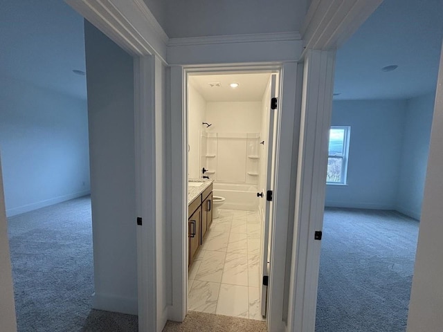 hall featuring light carpet and ornamental molding