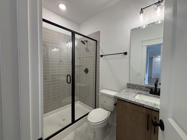 bathroom featuring an enclosed shower, vanity, and toilet