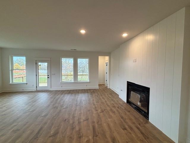 unfurnished living room with wood-type flooring