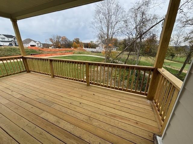 wooden deck with a lawn