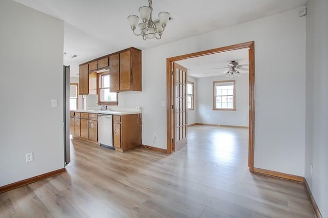 kitchen with ceiling fan with notable chandelier, dishwasher, and light wood-type flooring