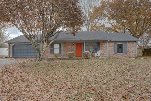 single story home with a garage and a front lawn