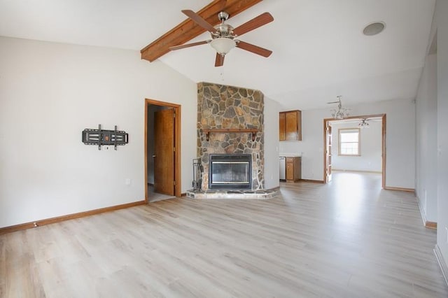 unfurnished living room with lofted ceiling with beams, ceiling fan, a fireplace, and light hardwood / wood-style flooring