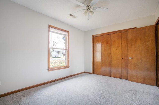 unfurnished bedroom with light carpet, a closet, and ceiling fan