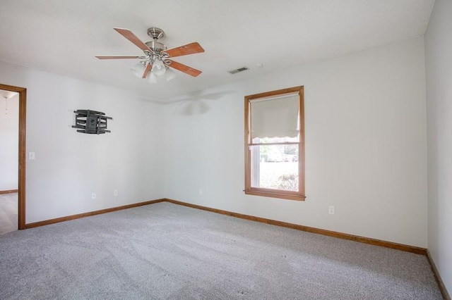 spare room featuring carpet floors and ceiling fan