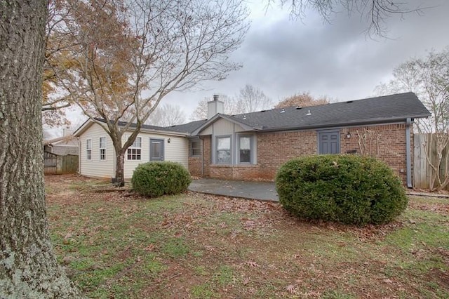 view of front of house with a patio area and a front yard