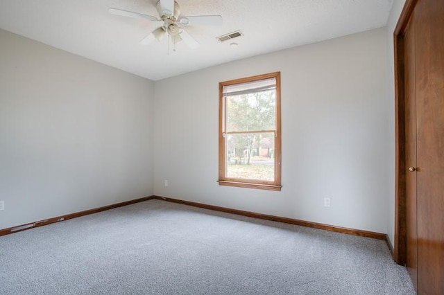 spare room with ceiling fan and carpet flooring