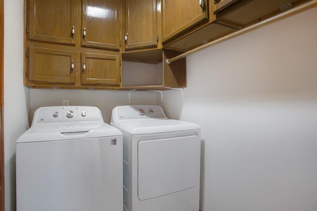 laundry room with cabinets and separate washer and dryer