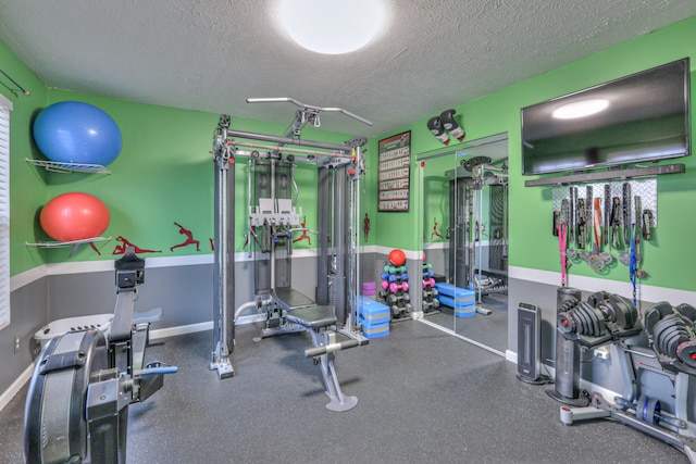 workout area featuring a textured ceiling