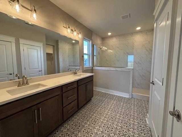 bathroom with vanity and a tile shower