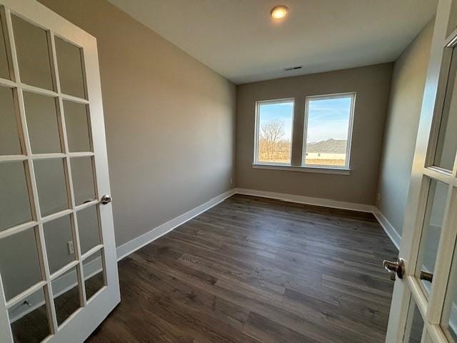 unfurnished room with dark hardwood / wood-style floors