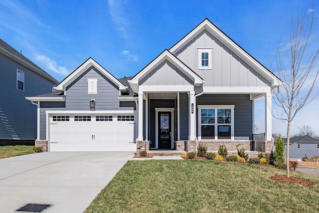 view of front of house with driveway, a porch, a front lawn, a garage, and board and batten siding