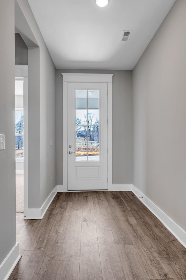 interior space featuring wood finished floors, visible vents, and baseboards