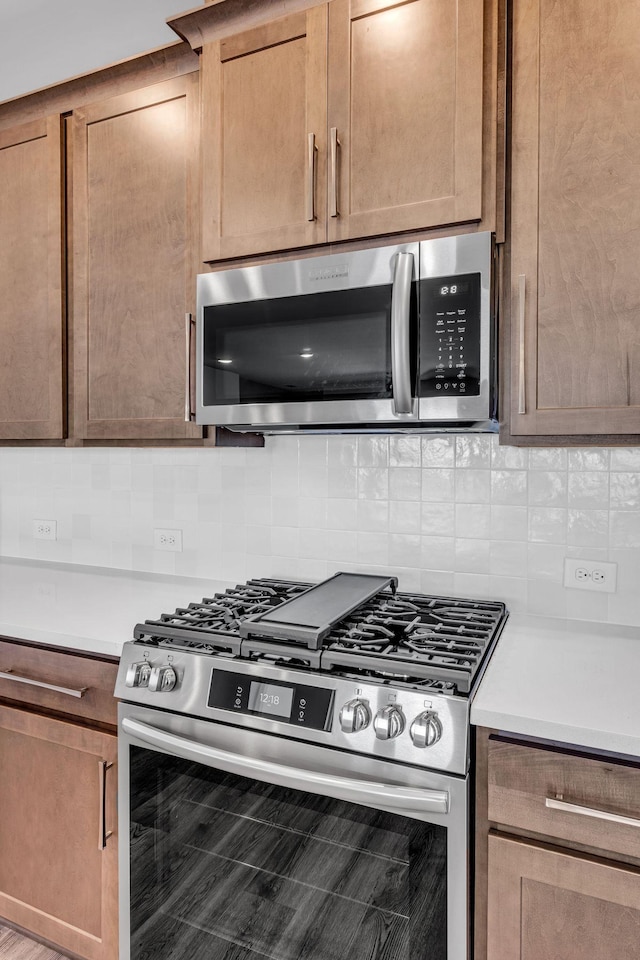 kitchen with light countertops, tasteful backsplash, and stainless steel appliances