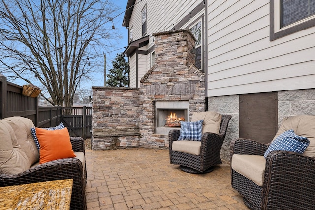 view of patio / terrace featuring an outdoor stone fireplace