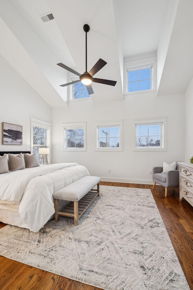 bedroom featuring ceiling fan, high vaulted ceiling, and dark hardwood / wood-style flooring