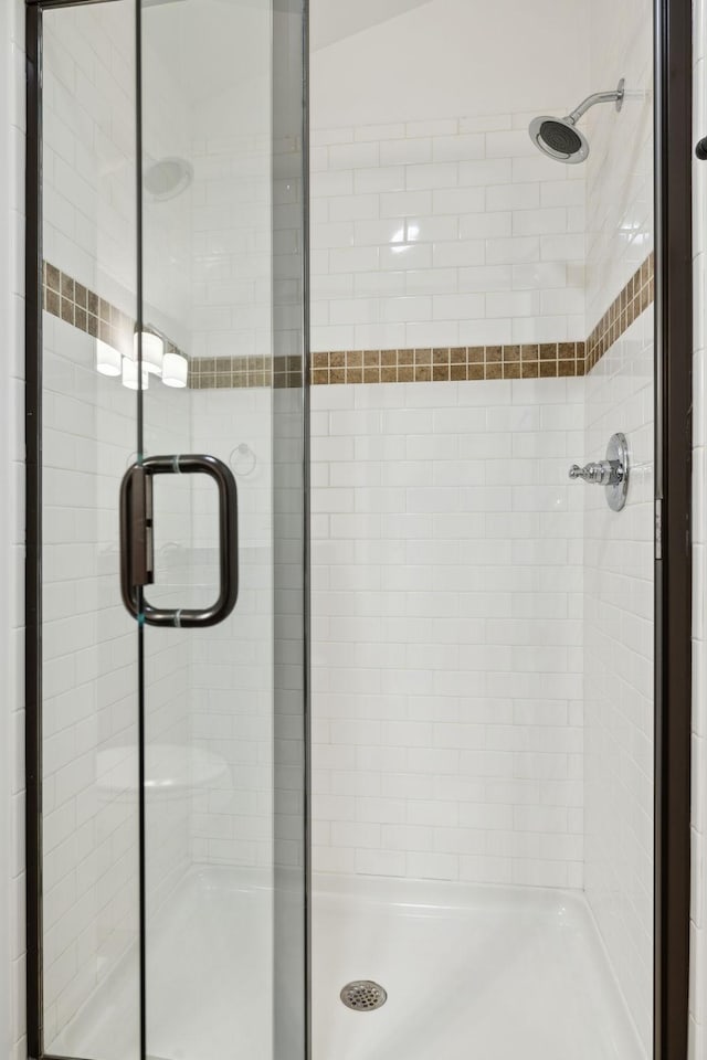 bathroom with a shower with shower door