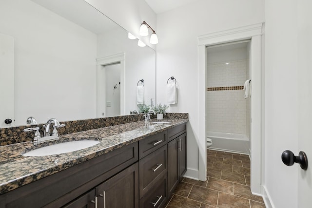 full bathroom with vanity, toilet, and tiled shower / bath combo