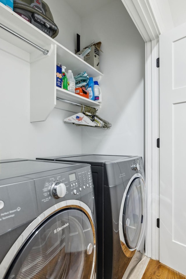 washroom featuring separate washer and dryer and light hardwood / wood-style floors