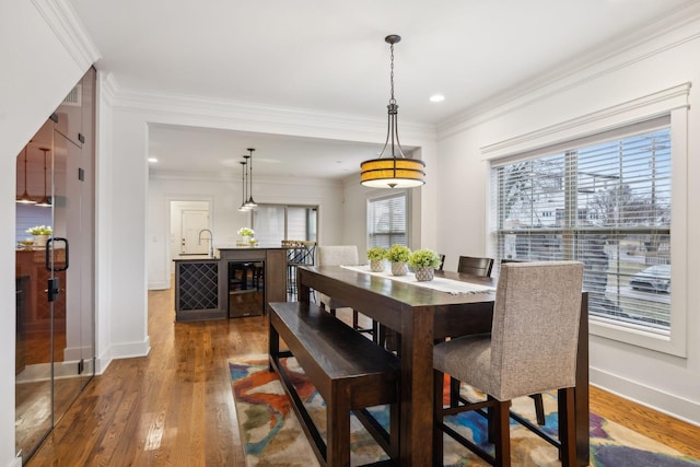 dining area with wine cooler, ornamental molding, and dark hardwood / wood-style floors