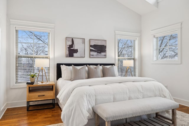 bedroom with hardwood / wood-style flooring and lofted ceiling