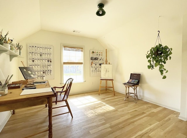 office with vaulted ceiling and hardwood / wood-style floors