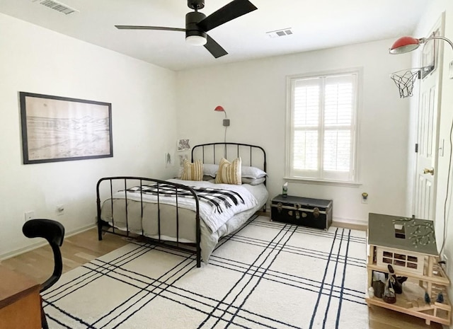 bedroom with hardwood / wood-style flooring and ceiling fan