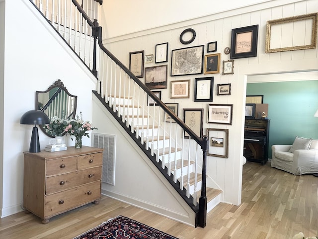 stairs featuring hardwood / wood-style flooring