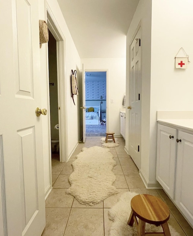 hall featuring light tile patterned flooring