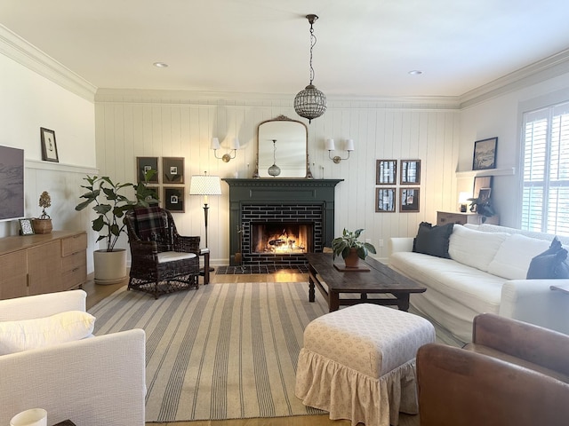 living room featuring hardwood / wood-style flooring, a fireplace, and crown molding