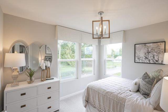 bedroom with a chandelier and carpet