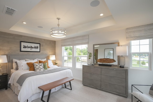 carpeted bedroom featuring crown molding, a chandelier, and a tray ceiling